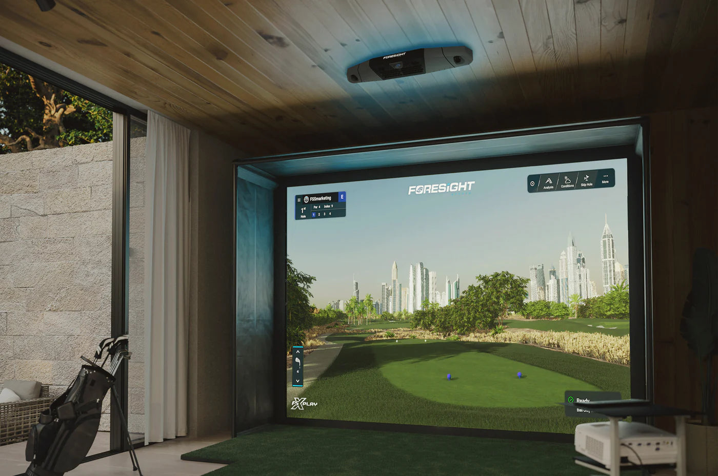 Foresight Falcon Launch Monitor displayed in modern indoor golf simulator with realistic course visualization.
