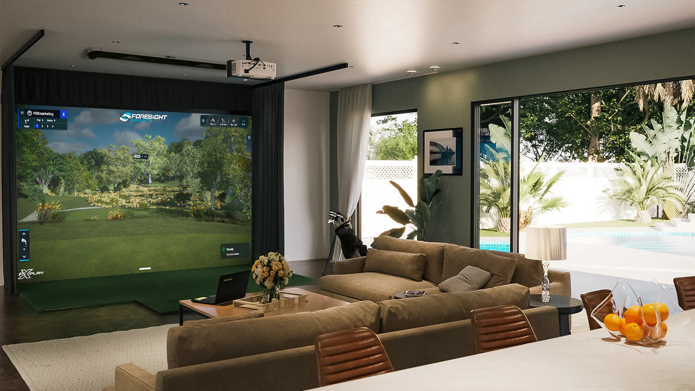 GCHawk Launch Monitor displayed in a home golf simulator setting with a realistic outdoor landscape on screen.